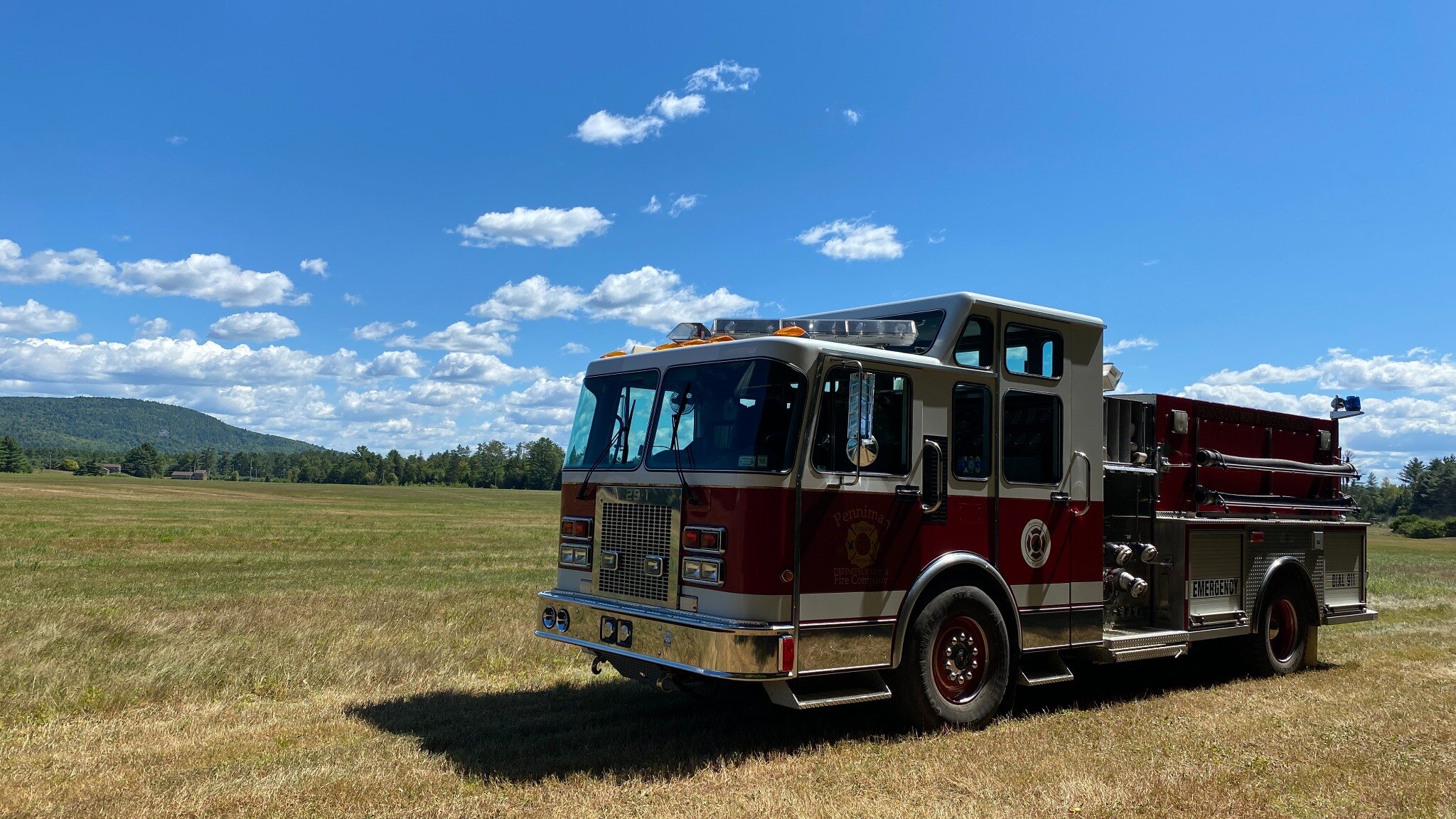 Penniman Engine 29-1 parked in an open field beneath a wide blue sky